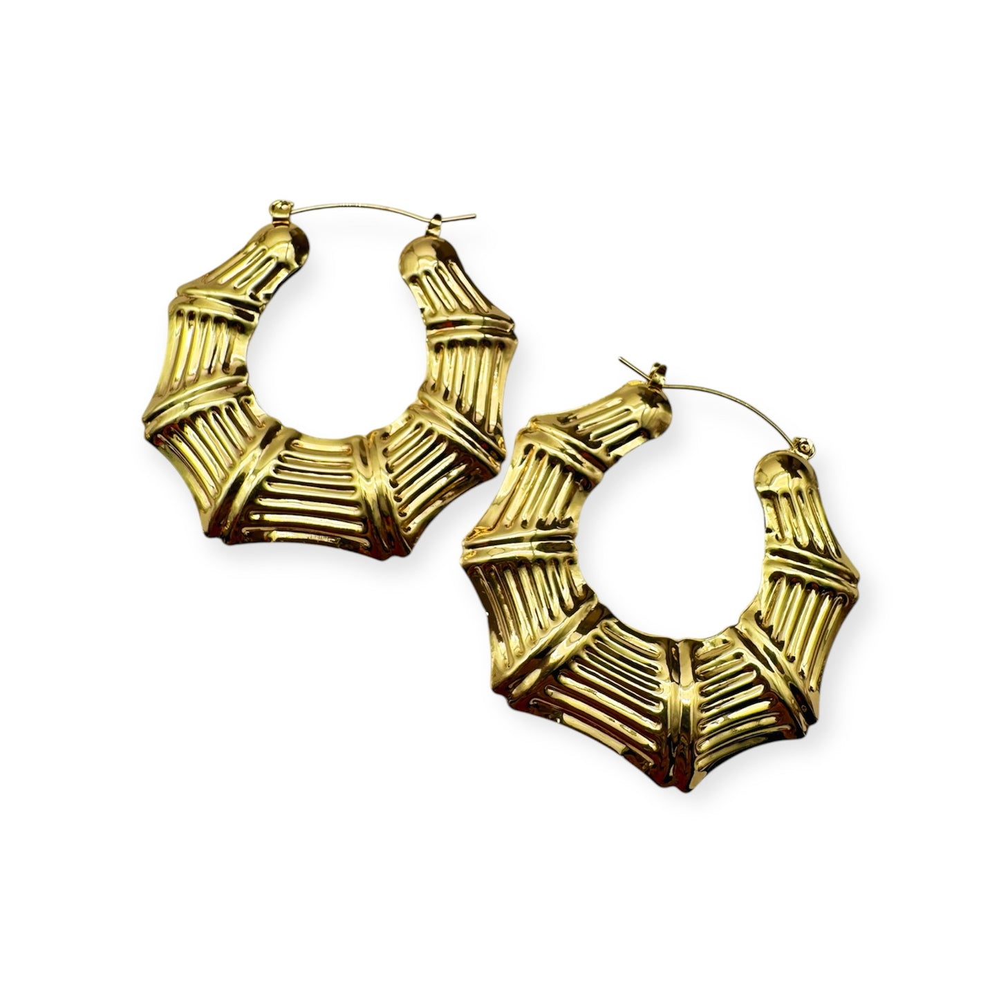 A pair of vintage gold hoop earrings with a textured surface.