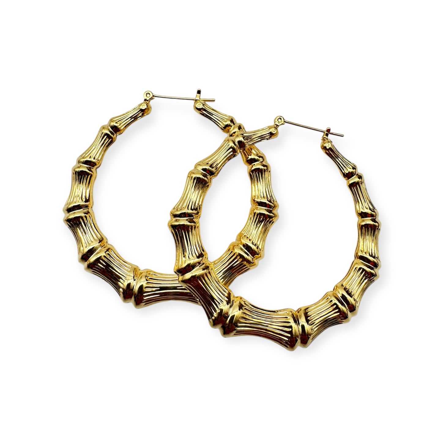 A pair of vintage gold hoop earrings with a textured surface. Gold bamboo hoop earrings by Everythang Dope, inspired by 90s streetwear.