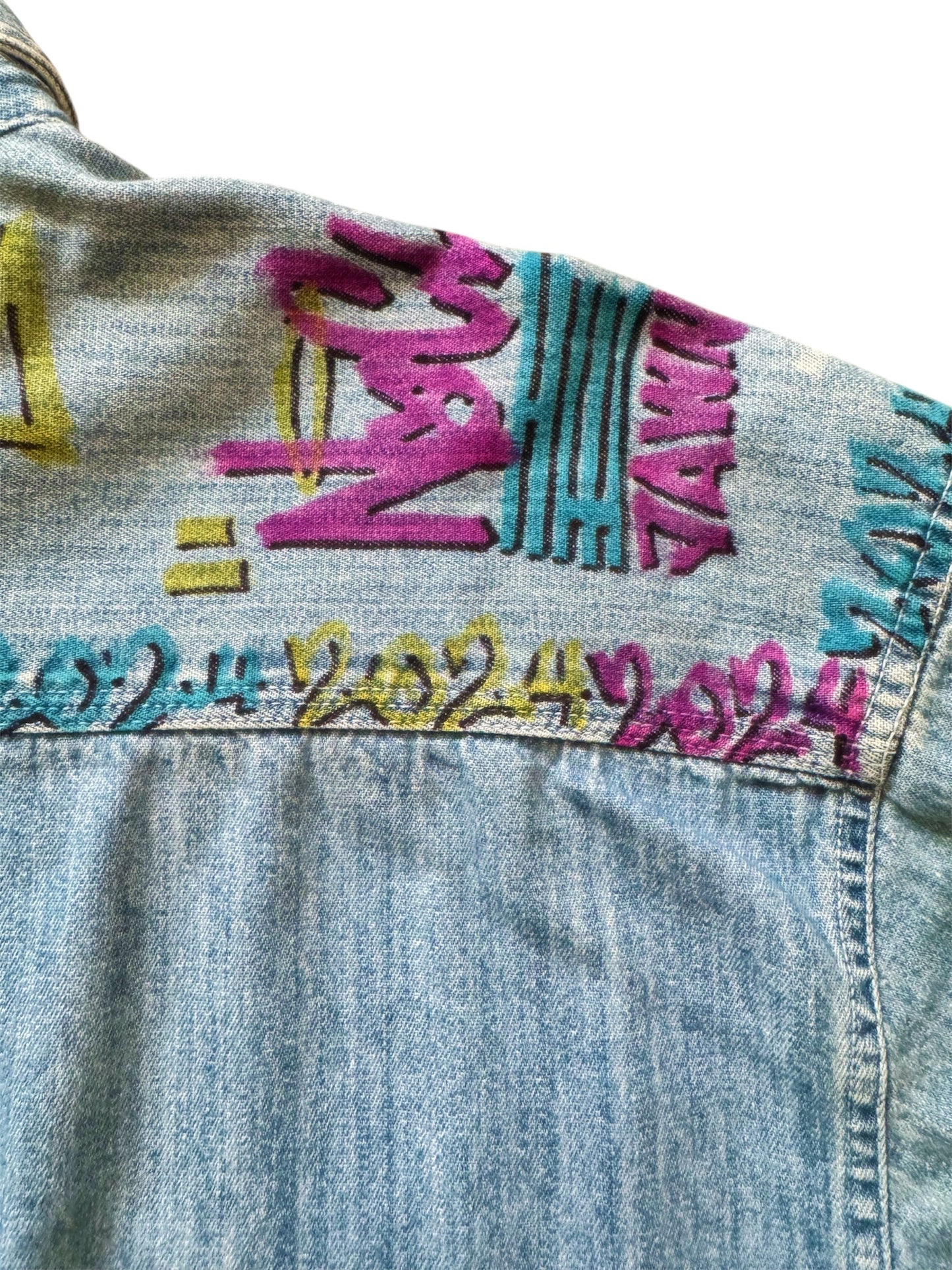 Custom denim jeans with Naclie Jawn multicolor graffiti by Everythang Dope, one-of-one streetwear.