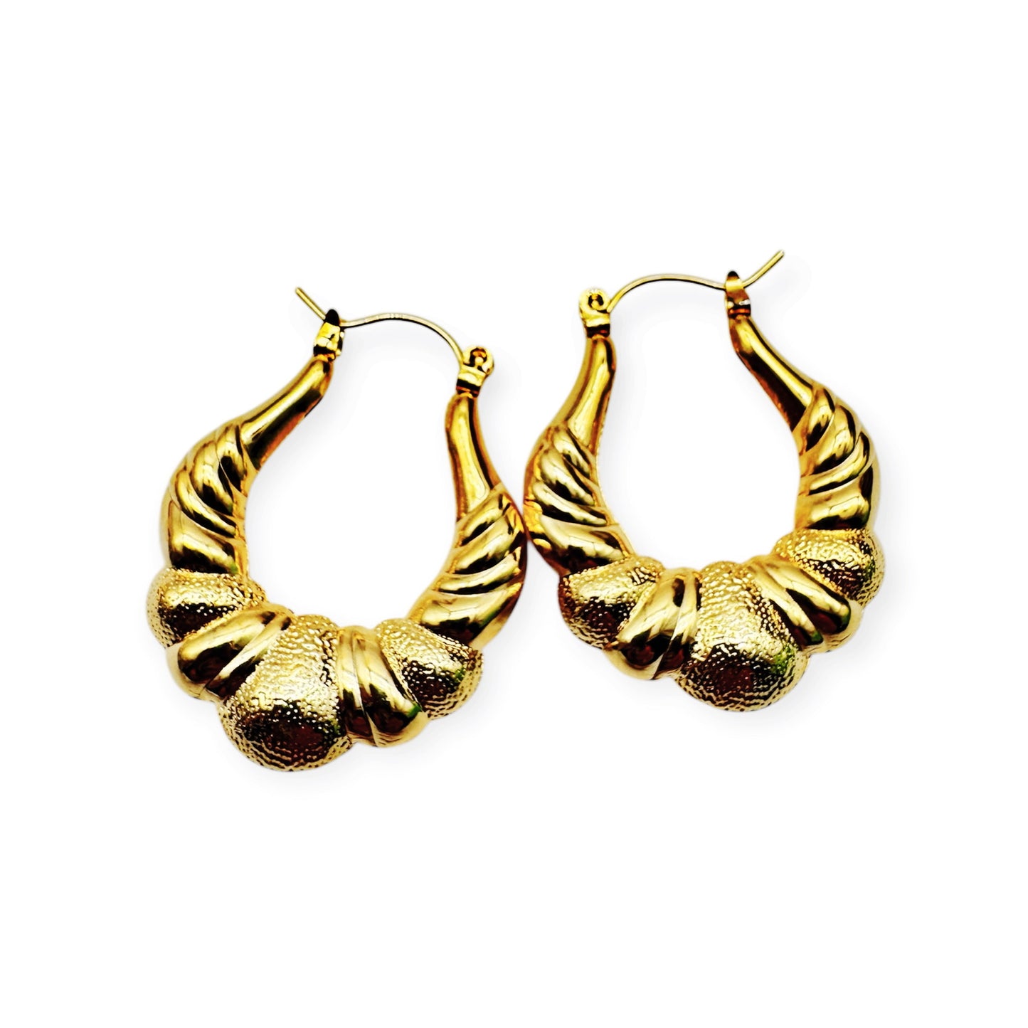 A pair of vintage gold hoop earrings with a textured surface. Gold door knocker earrings by Everythang Dope, classic 90s hip-hop accessory.