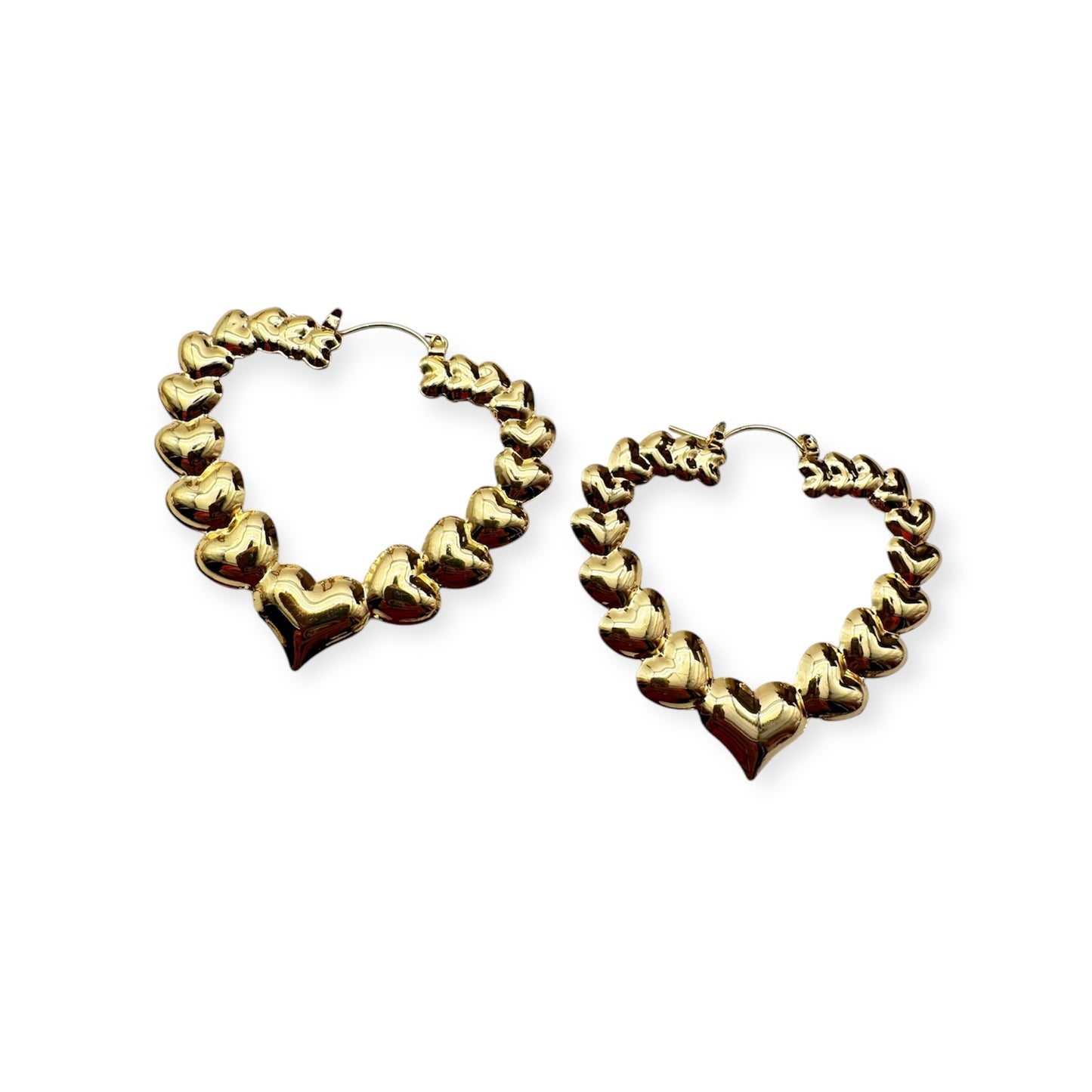 A pair of vintage gold hoop earrings with a textured surface.