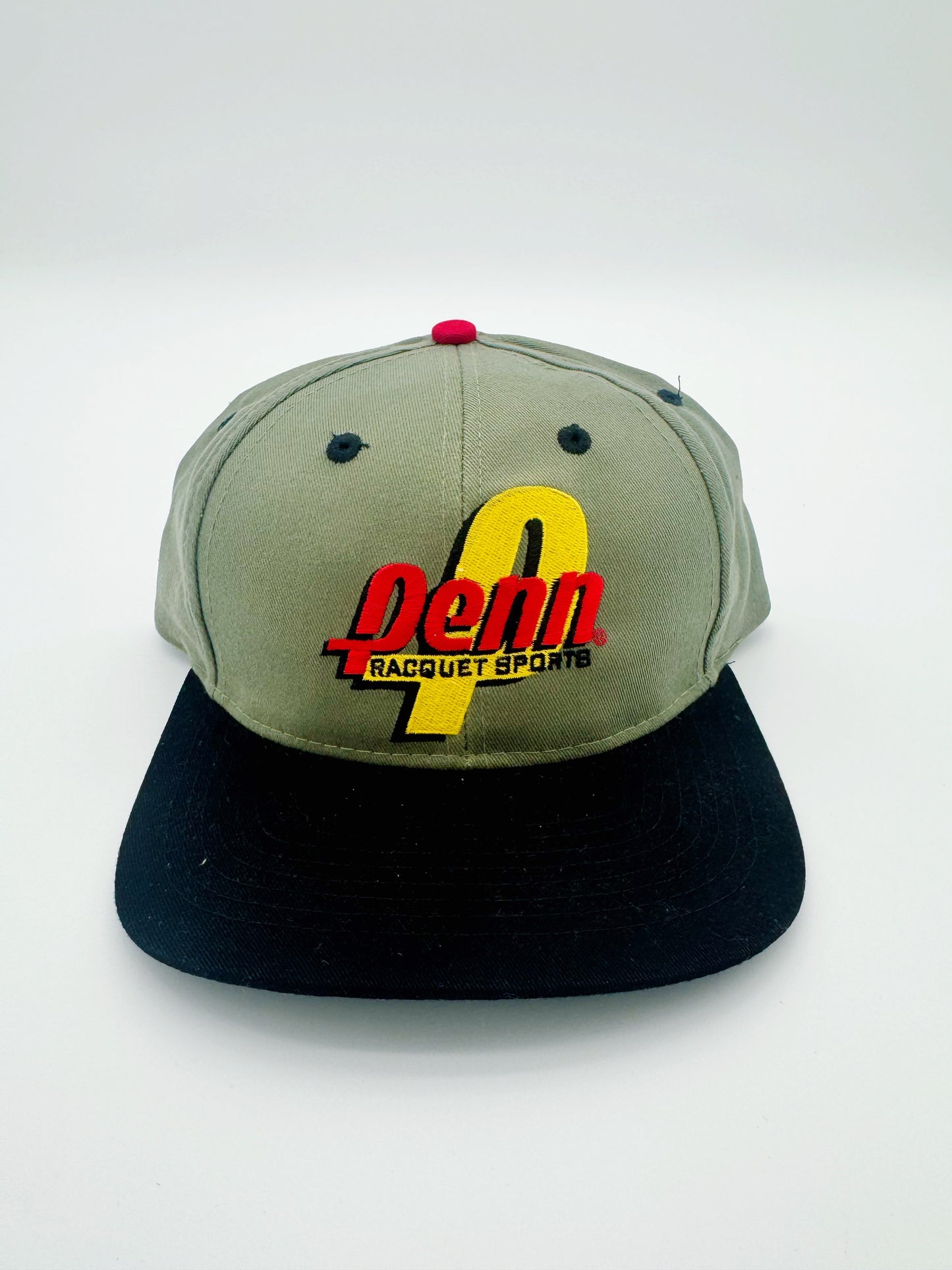 A vintage 1998 Penn Racket Sports golf strapback cap with green crown and black visor, featuring red and yellow embroidery on the front.