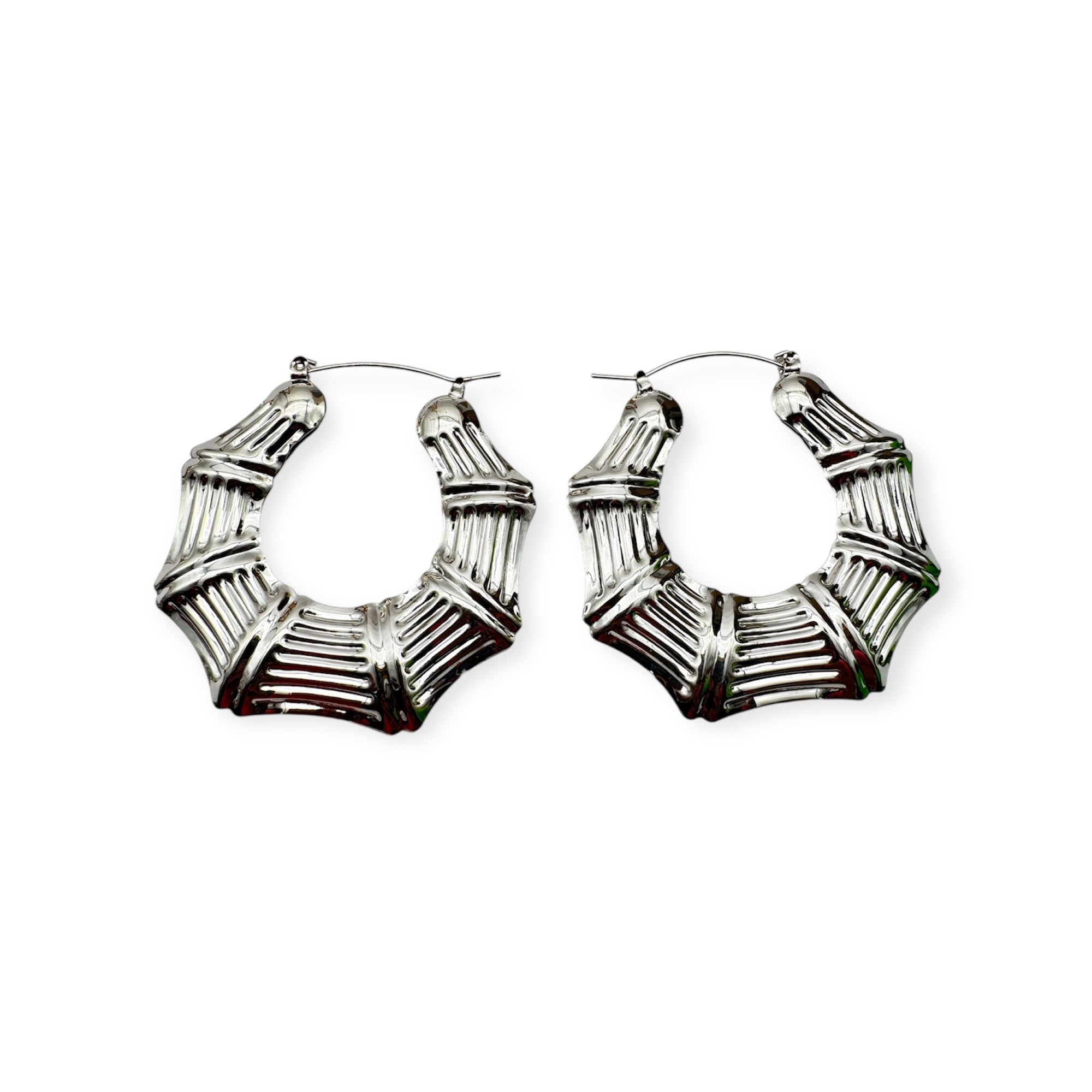 A pair of vintage silver hoop earrings with a textured surface on a white background.