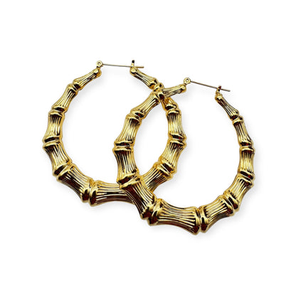 A pair of vintage gold hoop earrings with a textured surface.  Gold bamboo hoop earrings by Everythang Dope, inspired by 90s streetwear.
