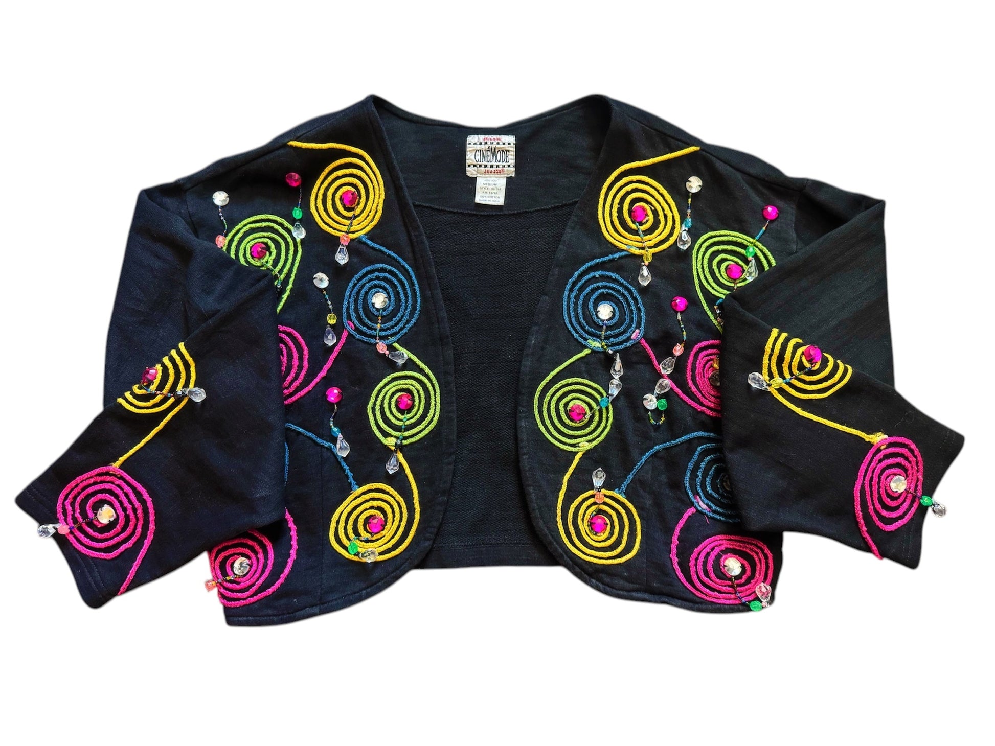 A vintage jacket with multicolored geometric patterns and beaded details on a black background.
