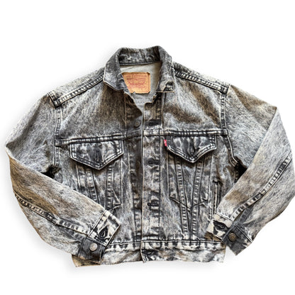 A black acid wash Levi's denim jacket laid out flat on a white background.