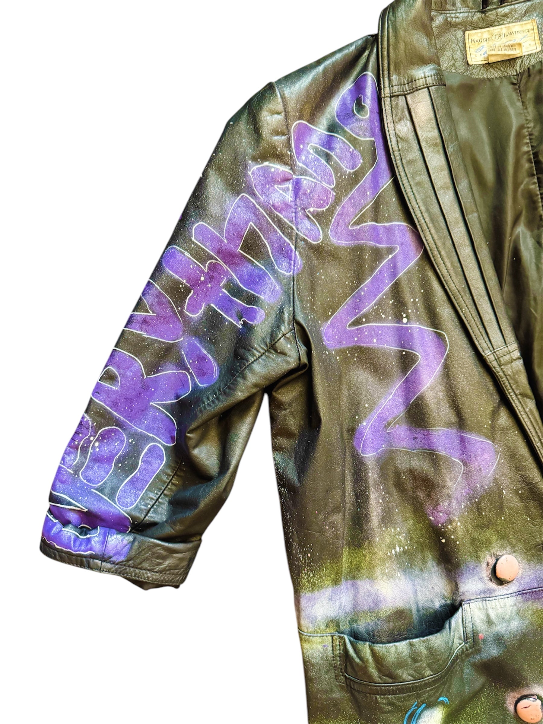 Graffiti-painted 80s leather trench coat from Everythang Dope, bold retro outerwear.
