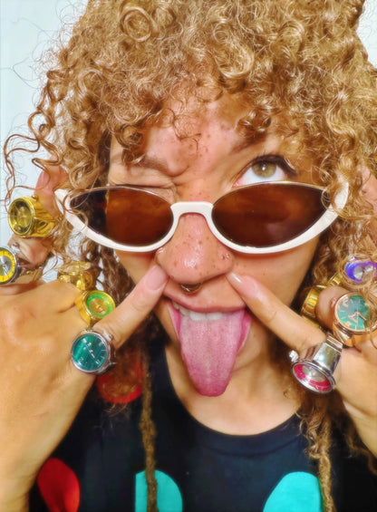 Lifestyle shot of model with curly hair wearing Cutie Eye sunglasses and vintage ring watches by Everythang Dope.