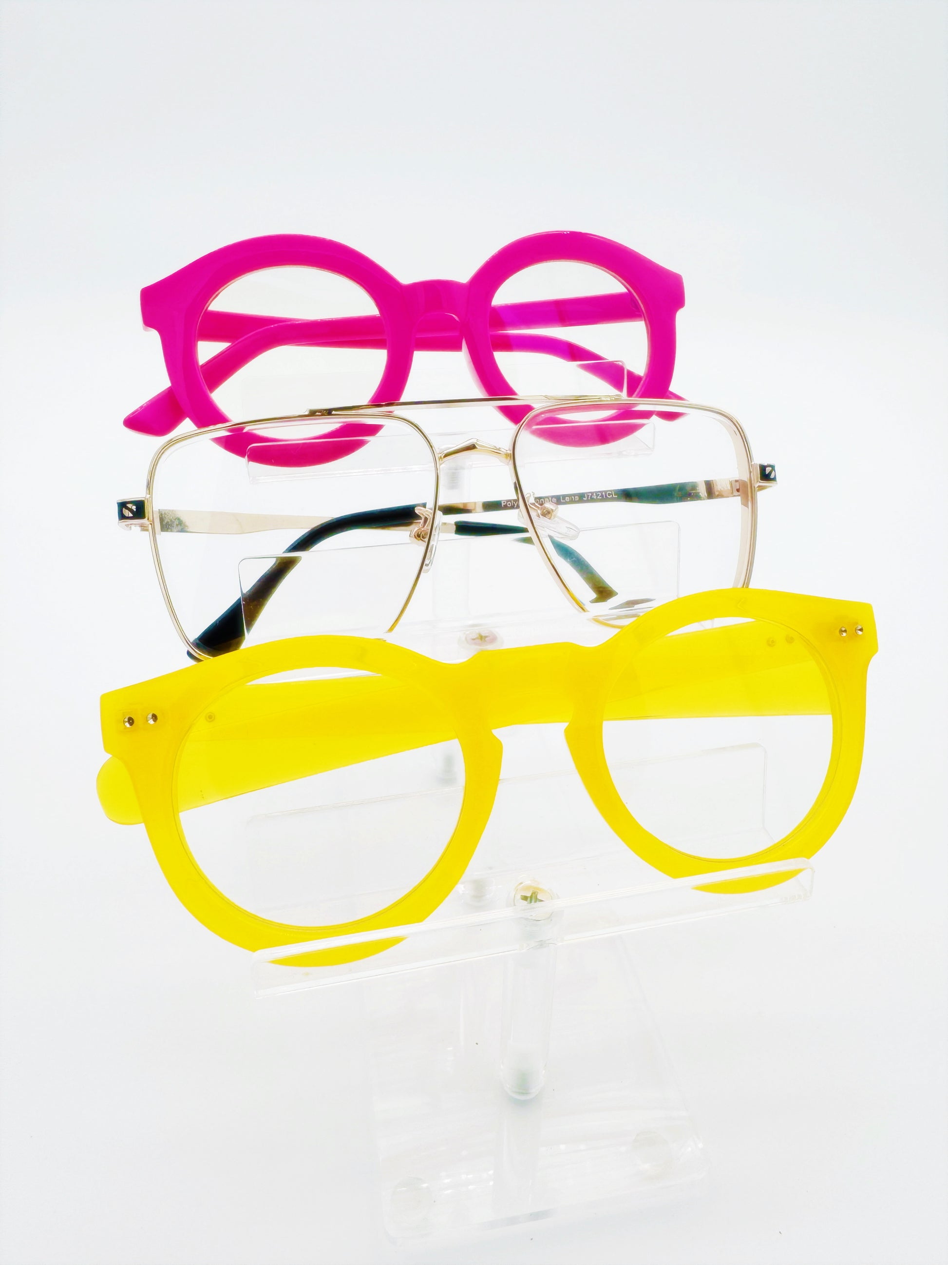 Two pairs of round glasses, one with a pink frame and the other with a yellow frame, displayed against a white background.