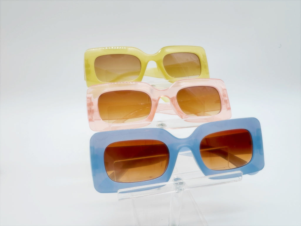 Three pairs of square-framed sunglasses in yellow, pink, and blue colors displayed against a white background.
