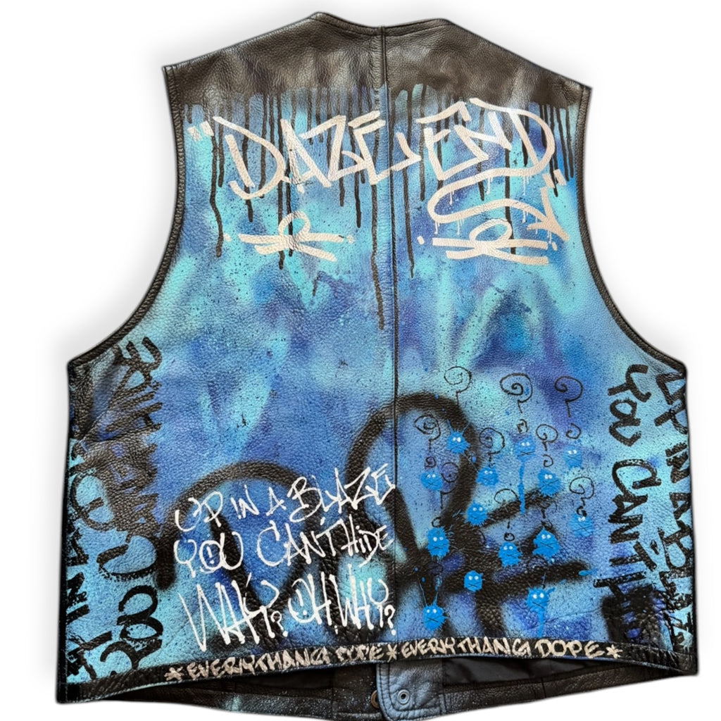 Custom painted black and blue denim vest with text and abstract designs in spray paint.