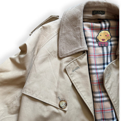 A beige vintage Bradley Jons trench coat with a mandarin collar, featuring a button closure and a plaid patterned interior lining.