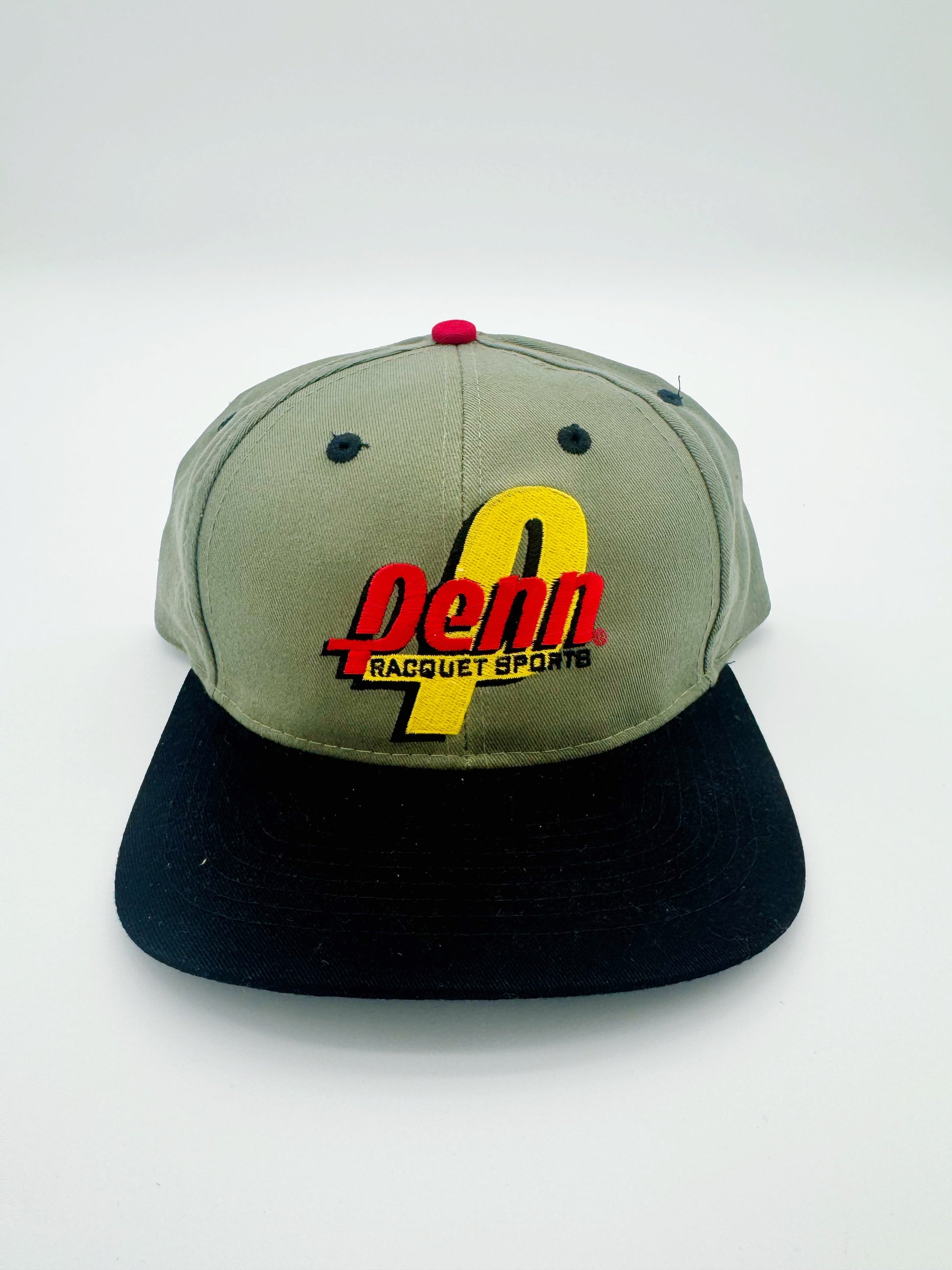 A vintage 1998 Penn Racket Sports golf strapback cap with green crown and black visor, featuring red and yellow embroidery on the front.