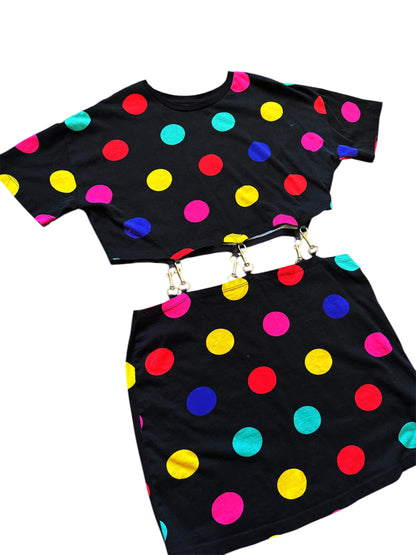 A black dress with vibrant multicolored dots, including blue, pink, yellow, and red, with a belt. Vintage red 80s top with abstract Art Deco design, retro fashion from Everythang Dope.
